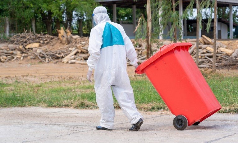 man with a waste bin